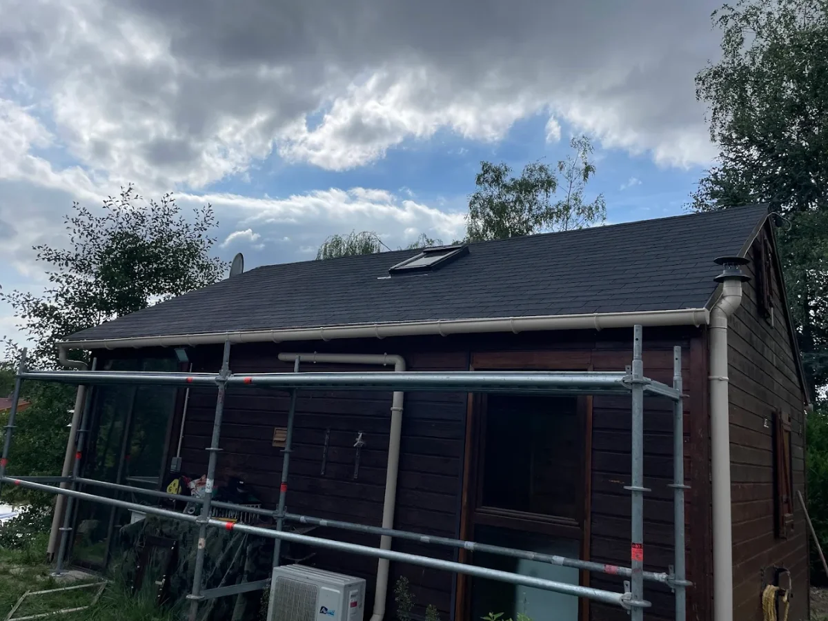 Extension en bois avec toiture neuve en ardoise, échafaudage encore en place